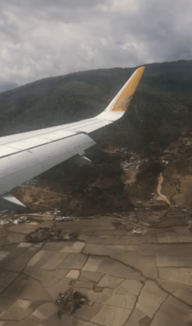 Wing of Drukair plane, as it prepares to land in Paro Airport, Bhutan